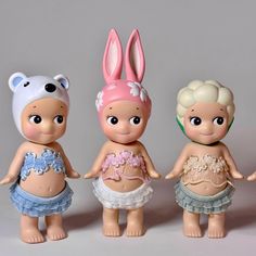 three little dolls are standing next to each other with bunny ears on their heads and body