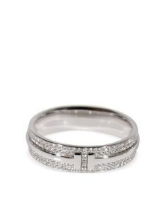 18kt white gold pavé setting white diamonds totalling 0.57ct eternity band signature Tiffany T design polished finish Condition: EXCELLENT. This previously owned item is in near-perfect condition with no signs of damage or use. Purchasing this item continues its narrative and reduces the environmental impact by avoiding the use of new resources needed to make the product from scratch, such as water, materials and electricity, and avoiding additional manufacturing impact. Learn more about what makes a product Conscious on our Conscious Criteria page Tiffany And Co Silver Ring, Tiffany Jewelry Rings, Tiffany T Ring, Tiffany & Co, Tiffany And Co Rings, Most Expensive Ring, Tiffany And Co Ring, Tiffany Ring, Tiffany Co Rings