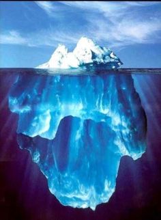 an iceberg floating in the ocean with blue water