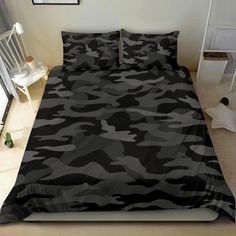 a bed with black and grey camouflage print on it