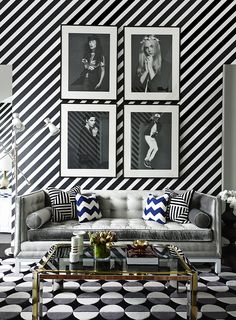 a living room with black and white wallpaper, striped walls and two pictures on the wall