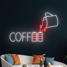 a neon sign that says coffee on the side of a wall with a couch in front of it