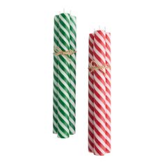 two green and red striped candles tied with twine on white background, side by side