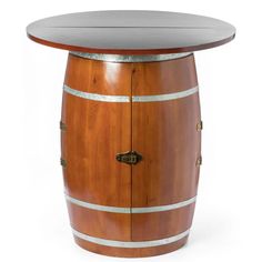 a wooden barrel table sitting on top of a white floor next to a metal door