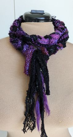 a purple and black scarf on top of a mannequin