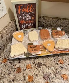 some cookies are sitting on a table near a sign that says fall is my favorite time of the year