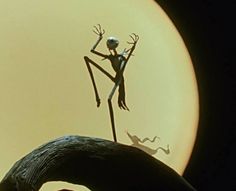 an alien standing on top of a black object