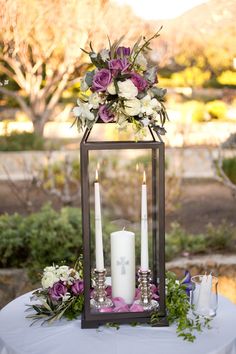 a table with candles and flowers on it