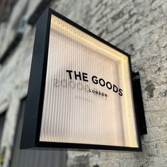 the goods store sign is lit up outside