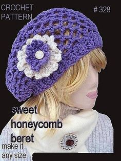 a crochet hat with flowers on the front and side, is shown in purple