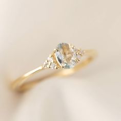 an engagement ring with a blue topazte and white diamonds on it's side