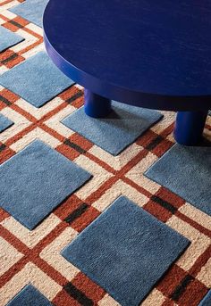 a blue coffee table sitting on top of a rug