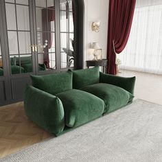 a green couch sitting on top of a white rug