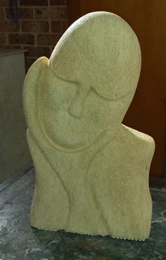 a stone sculpture sitting on top of a table