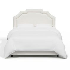 a bed with white linens and pillows on top of the headboard, in front of a white background