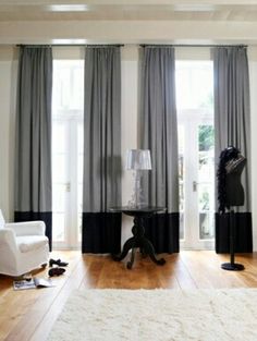 a living room filled with furniture and curtains