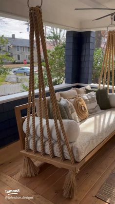 a porch swing bed with pillows on it