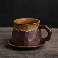 a brown cup sitting on top of a wooden table