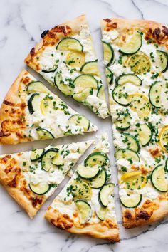 sliced cucumber and cheese pizza on a marble surface