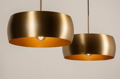 two gold pendant lights hanging from the ceiling