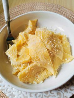 a white bowl filled with pasta on top of a table