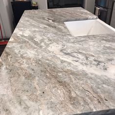 a kitchen counter top with a sink in it