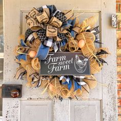 a wreath that says farm sweet farm on the front door with eggs and burlocks