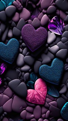 many different colored hearts sitting on top of rocks