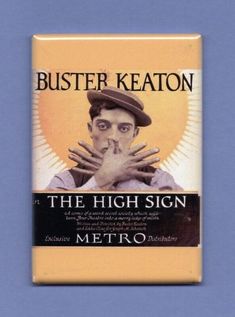 the high sign by buster keaton on a blue background with his hands in front of his face