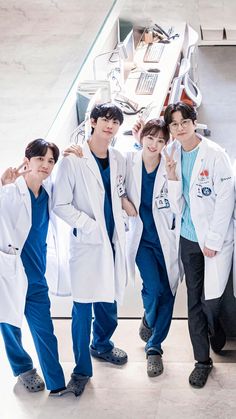 four young men in lab coats posing for a photo