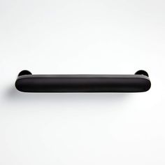 a black handle on a white wall