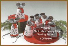 a group of mice sitting on top of red buckets with christmas decorations around them