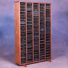 a large wooden rack with many cd's in it on a blue background,