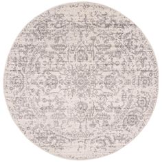 a round rug with grey and white designs on the bottom, in front of a white background