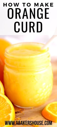 a jar filled with orange curd sitting on top of a wooden table next to sliced oranges