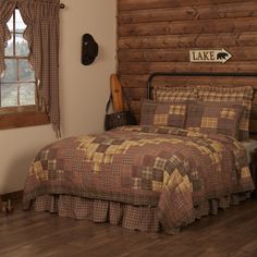 a bed in a bedroom next to a window with a wooden headboard and foot board