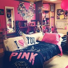 a bedroom decorated in pink and black with pictures on the wall