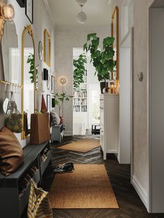 the hallway is decorated in white and gold with lots of greenery on the wall