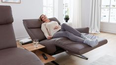 a woman reclining on the couch in her living room