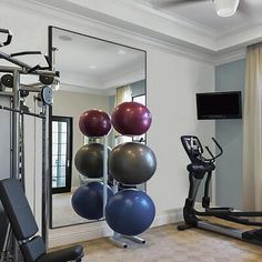 a gym with exercise equipment and mirrors