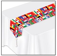 a white table with flags on it and a tassel hanging from the top of it