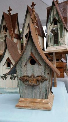 several bird houses are on display for sale