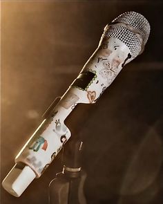 an old fashioned microphone is sitting on a stand