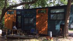 the tiny house is built into the side of the tree and has windows on both sides