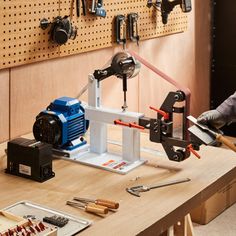 a man working with tools on a workbench