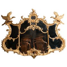 an ornately decorated mirror with birds on it