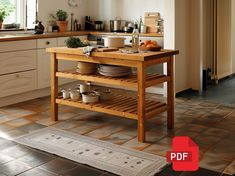 a kitchen island with pots and pans on it in the middle of a tiled floor