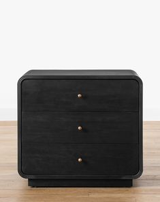 a black dresser sitting on top of a wooden floor