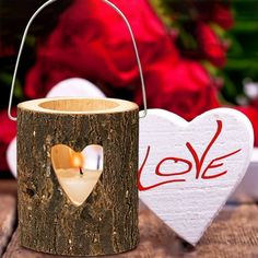 a wooden candle holder with a heart on it