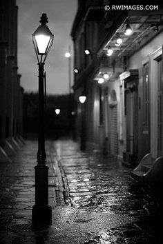 a street light on a rainy night in black and white